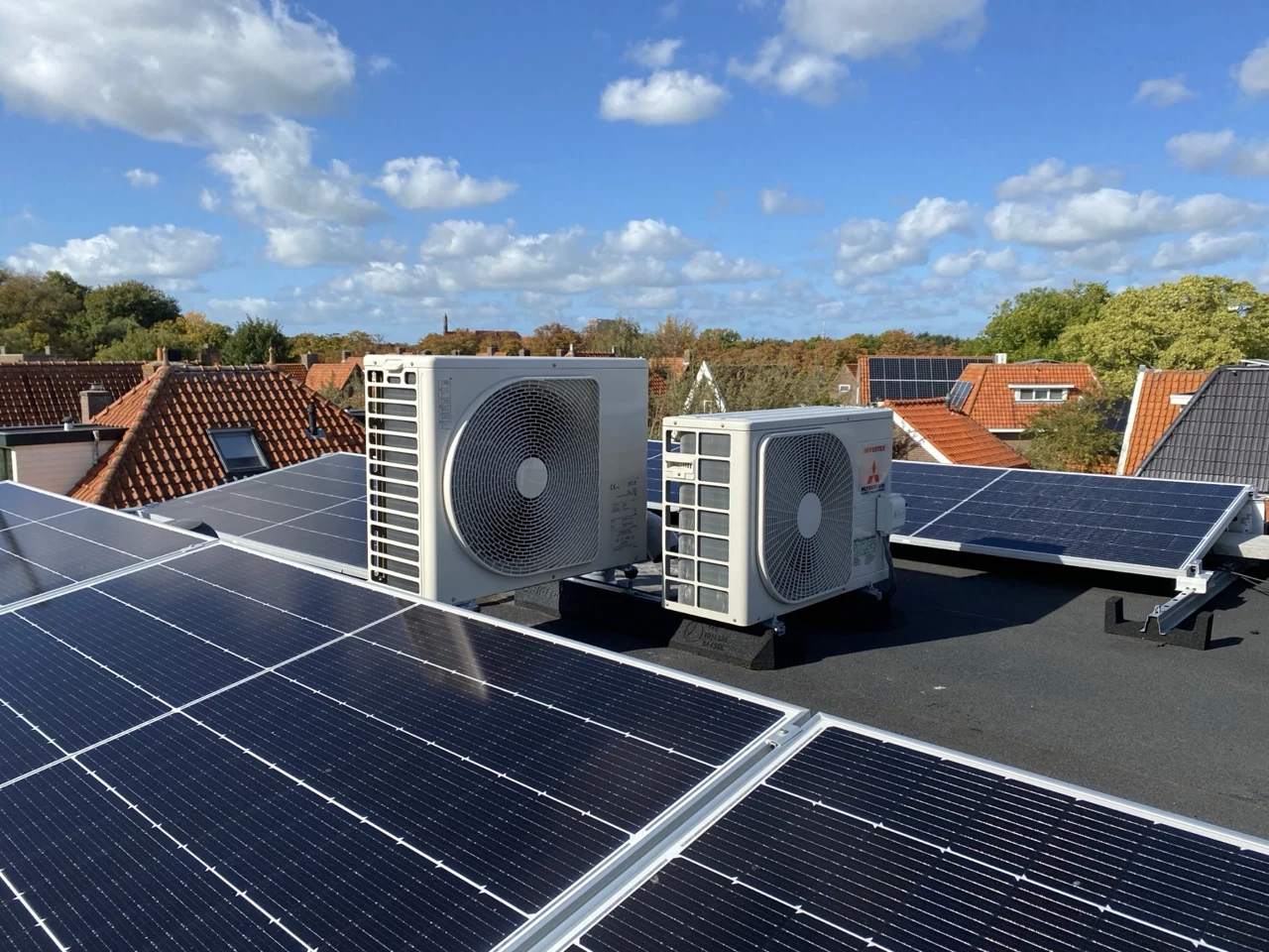 Eigen zonnepanelen met warmtepompbuitenunits op het dak